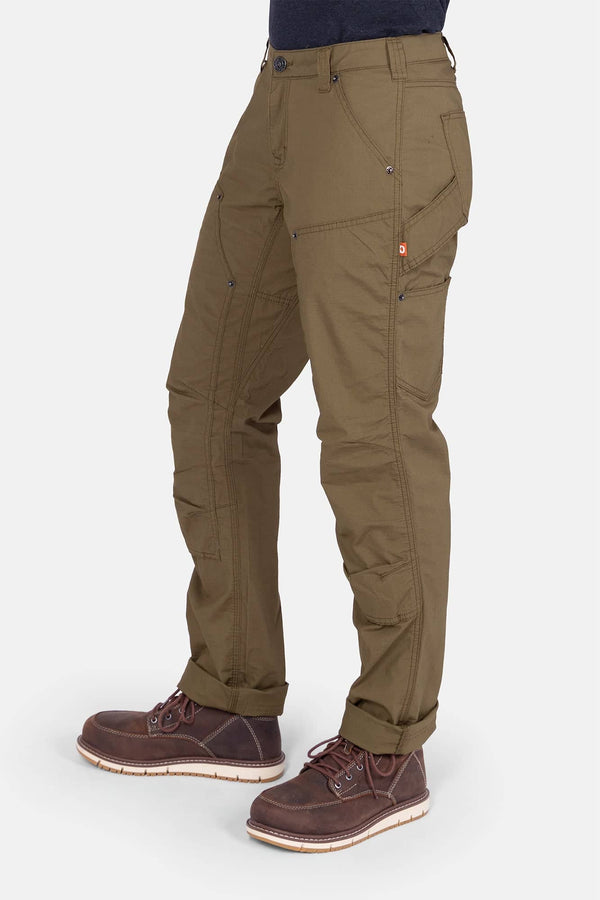 Side view of a woman wearing Dovetail Workwear's Anna Ultralight Trail Pant in Kelp Green Ripstop, featuring reinforced knees, nested pockets, and a straight leg fit