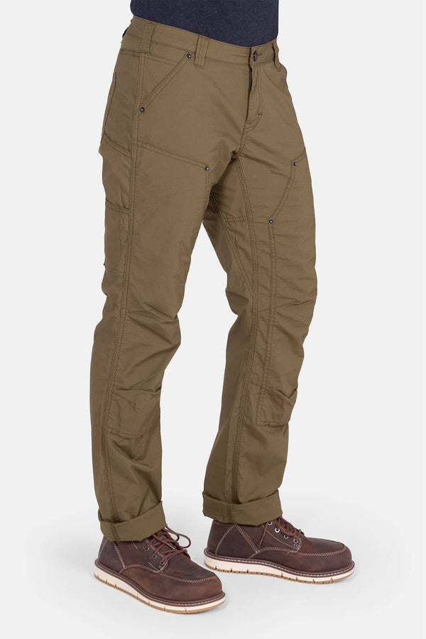 Anna Ultralight Trail Pant in Kelp Green Ripstop by Dovetail Workwear, featuring reinforced knees, nested pockets, and Hip Slot™ tool loop, shown cuffed on a woman wearing brown boots
