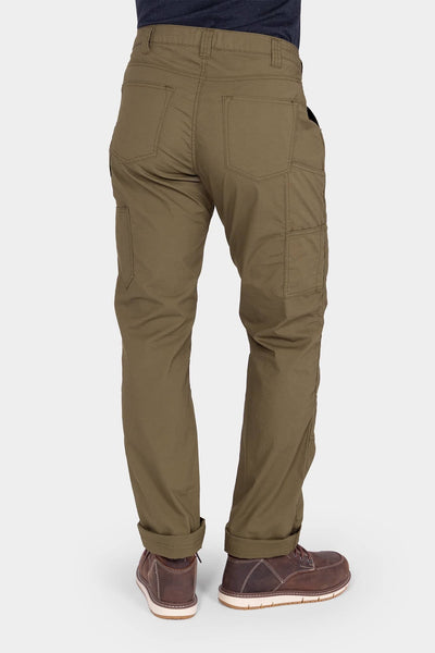 Back view of a woman wearing the Dovetail Workwear Anna Ultralight Trail Pant in Kelp Green Ripstop, showing nested pockets, reinforced knees, and rolled cuffs