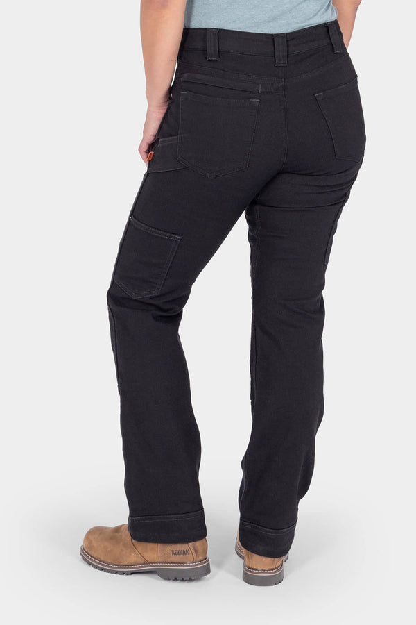 Back view of a woman wearing Dovetail Workwear's Britt Utility Pant in No Fade Black Canvas, featuring nested pockets, tool loop, and reinforced knees
