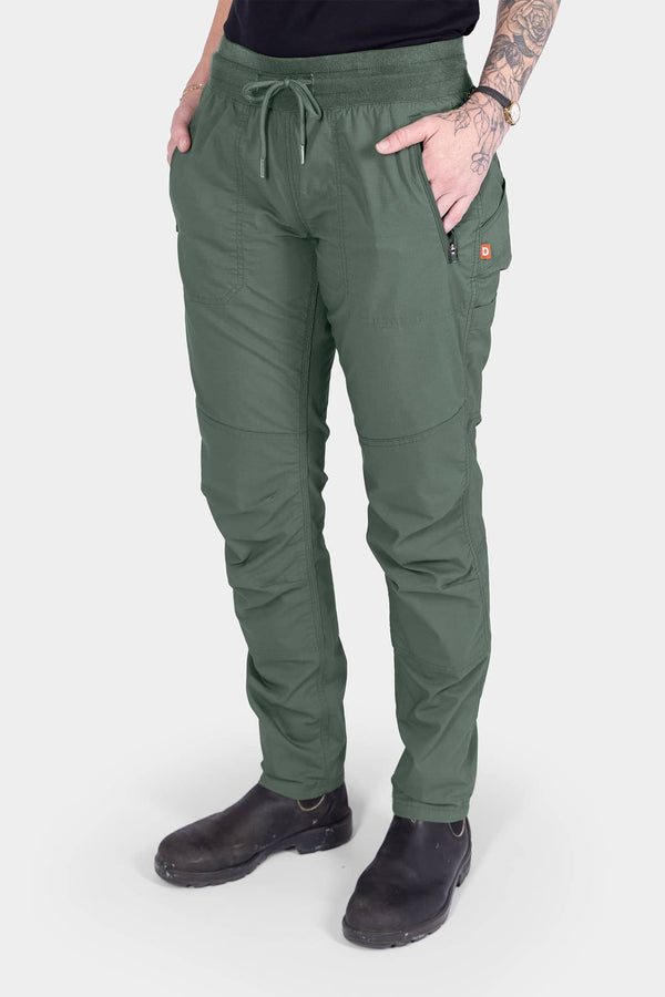 Dovetail Blue Christa X DIY COOLSWAP™ Pant by Dovetail Workwear shown on woman, featuring stretch waistband, front zip pockets, and reinforced knees