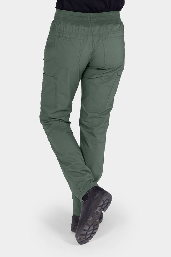 Back view of a woman wearing Dovetail Workwear's Christa X DIY COOLSWAP™ Pant in Aventurine Green, showcasing side pockets and reinforced knees