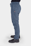Side view of a woman wearing Dovetail Workwear's Christa X DIY COOLSWAP™ Pant in Dovetail Blue, showcasing the slim leg fit, multiple pockets, and high-rise waistband with drawcord