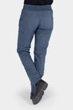 Back view of a woman wearing the Christa X DIY COOLSWAP™ Pant in Dovetail Blue by Dovetail Workwear, showing nested side pockets and slim leg fit