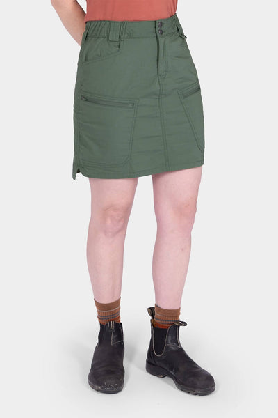 Back view of a woman wearing the Compass COOLSWAP™ Cargo Skort in Aventurine Green by Dovetail Workwear, featuring bellowed zip cargo pockets and a high-rise waistband