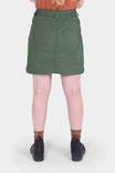 Back view of a woman wearing the Compass COOLSWAP™ Cargo Skort in Aventurine Green by Dovetail Workwear, showing bellowed zip cargo pockets and high-rise waistband