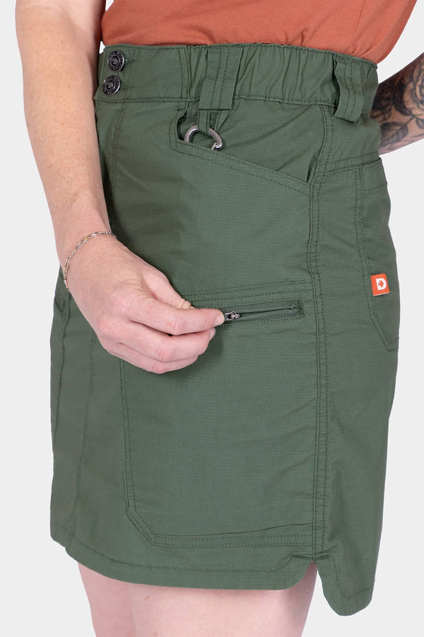 Detail view of the Compass COOLSWAP™ Cargo Skort in Aventurine Green by Compass, highlighting the zip cargo pocket and reinforced front pocket construction