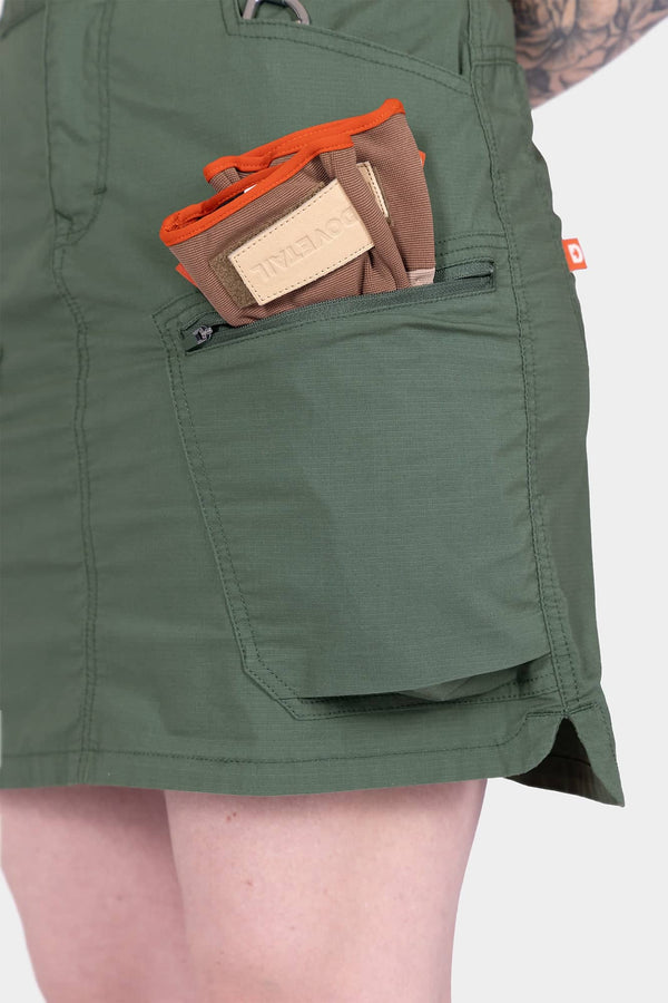 Detail view of the Compass COOLSWAP™ Cargo Skort in Aventurine Green by Compass, showcasing the bellowed zip cargo pocket and phone pocket functionality