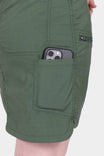 Close-up view of the Compass COOLSWAP™ Cargo Skort in Aventurine Green by Compass Workwear, showing a woman with a phone in the reinforced front pocket