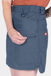 Woman wearing Dovetail Workwear Compass COOLSWAP™ Cargo Skort in Dovetail Blue, showcasing the zip cargo pocket and reinforced front pocket details