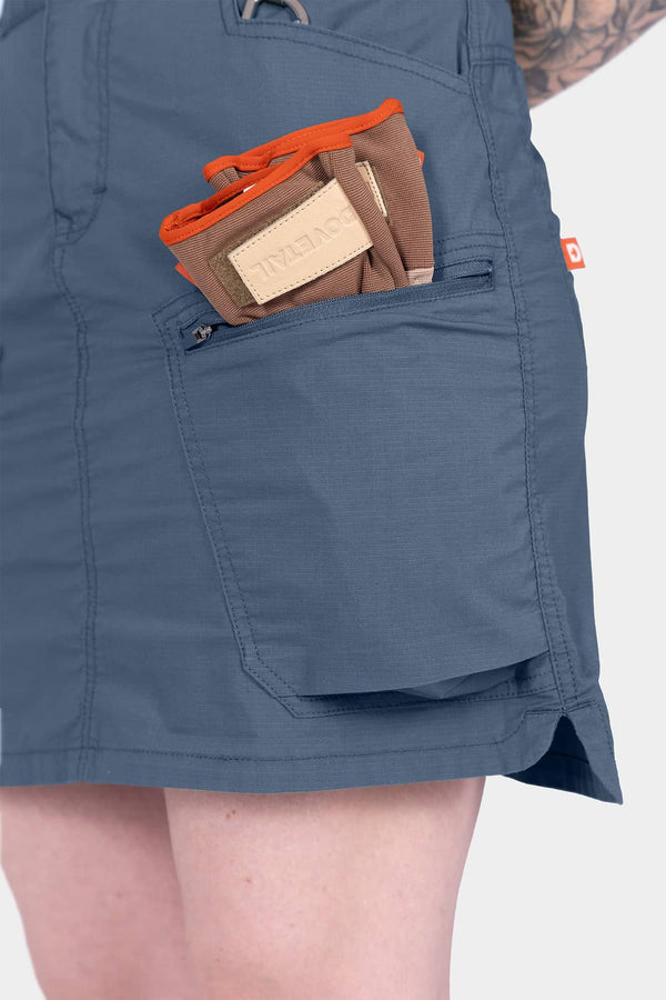 Detail view of the Dovetail Blue Compass COOLSWAP™ Cargo Skort by Dovetail Workwear, highlighting a bellowed zip cargo pocket and reinforced front pocket design