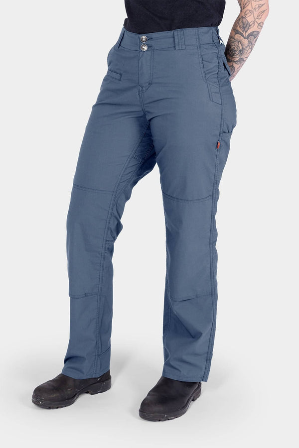 Dovetail Workwear Day X COOLSWAP™ Pant in Dovetail Blue worn by a woman, showcasing the relaxed straight leg fit, reinforced knee with kneepad slot, and functional pockets designed for work and outdoor activities