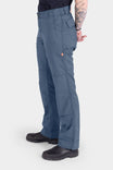 Side view of a woman wearing the Dovetail Workwear Day X COOLSWAP™ Pant in Dovetail Blue, showcasing the relaxed leg fit and reinforced knee with kneepad slot