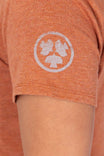 Detail view of the Dovetail Workwear GO TO™ Crew Neck Tee in Faded Paprika Orange, featuring the embroidered logo on the chest