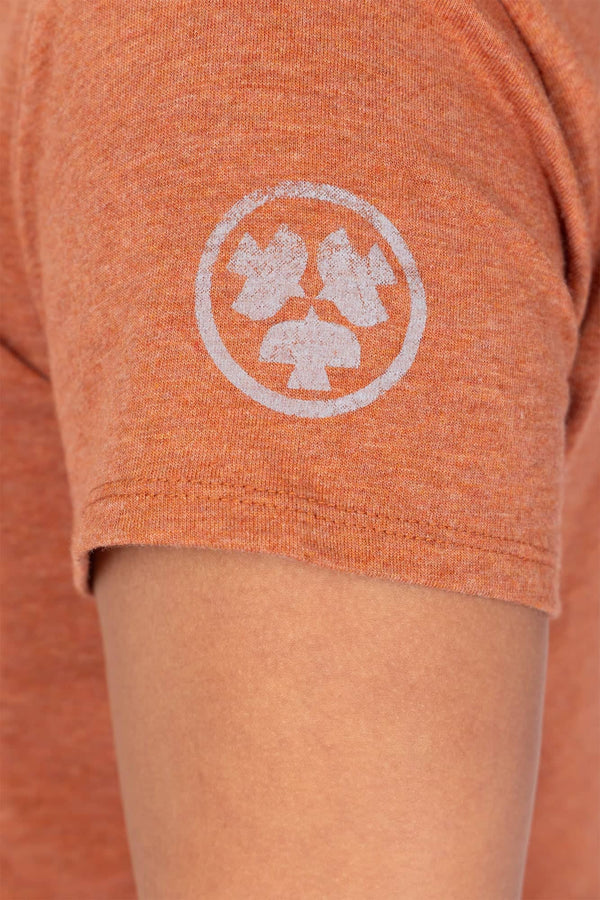 Detail view of the Dovetail Workwear GO TO™ Crew Neck Tee in Faded Paprika Orange, featuring the embroidered logo on the chest