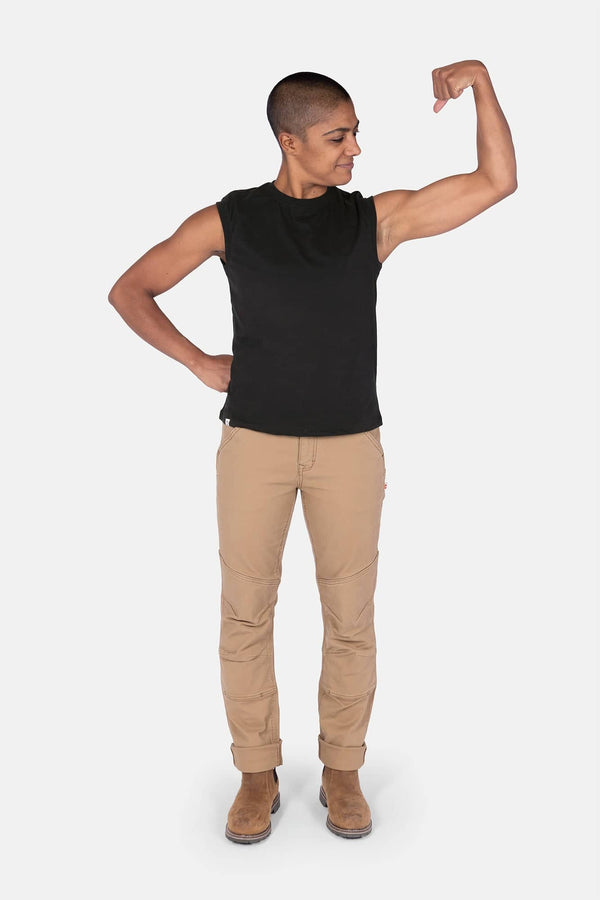 Black GO TO™ Tank Top by Dovetail Workwear worn by a woman flexing her arm, paired with khaki work pants and brown boots