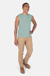 Patina Green GO TO™ Tank Top by Dovetail Workwear worn with khaki cargo pants, shown on a smiling woman in a front-facing pose