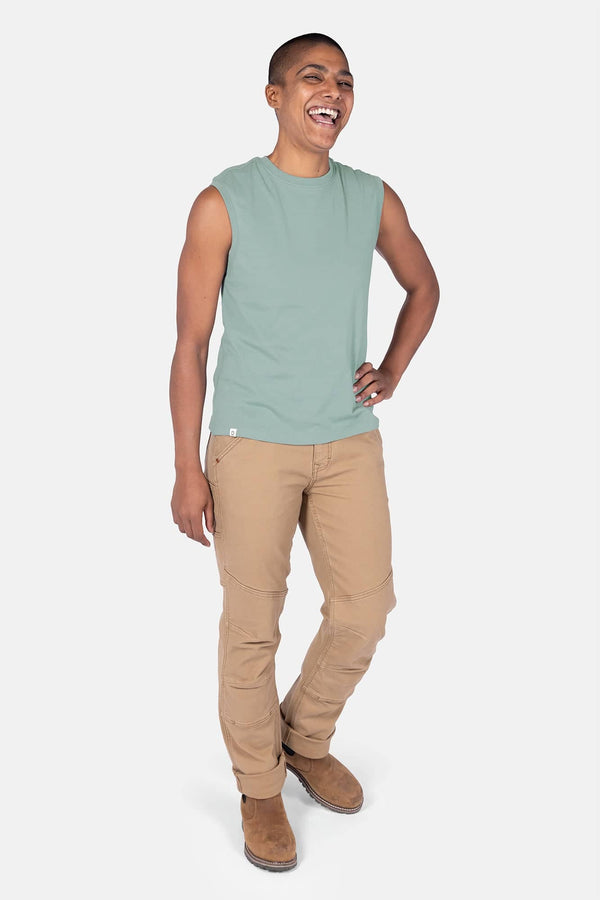 Patina Green GO TO™ Tank Top by Dovetail Workwear worn with khaki cargo pants, shown on a smiling woman in a front-facing pose