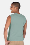 Back view of a woman wearing the Dovetail Workwear GO TO™ Tank Top in Patina Green, showcasing the relaxed fit and perfect armhole coverage