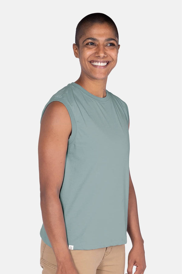 Side view of a woman wearing the Dovetail Workwear GO TO™ Tank Top in Patina Green, showcasing the relaxed fit and perfect armhole coverage
