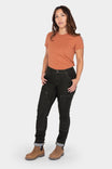 Maven Slim Pant in Heathered Black Graphene by Dovetail Workwear, featuring reinforced thigh and knee panels, Hip Slot™ Tool loop, and cuffed hem, worn with an orange tee and brown boots