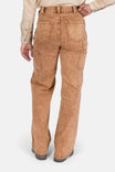 Back view of a woman wearing Dovetail Workwear's Old School Wide Leg Mineral Wash Jeans in Sunbaked Copper, showcasing the high-rise fit, nested side pockets, and wide leg silhouette