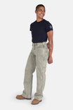 Side view of a woman wearing Dovetail Workwear's Old School Wide Leg Mineral Wash Jeans in Sunbaked Copper with a navy tee and brown boots