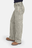 Side view of a woman wearing Dovetail Workwear Old School Wide Leg Mineral Wash Jeans in Sunbaked Copper with high-rise fit and nested side pockets
