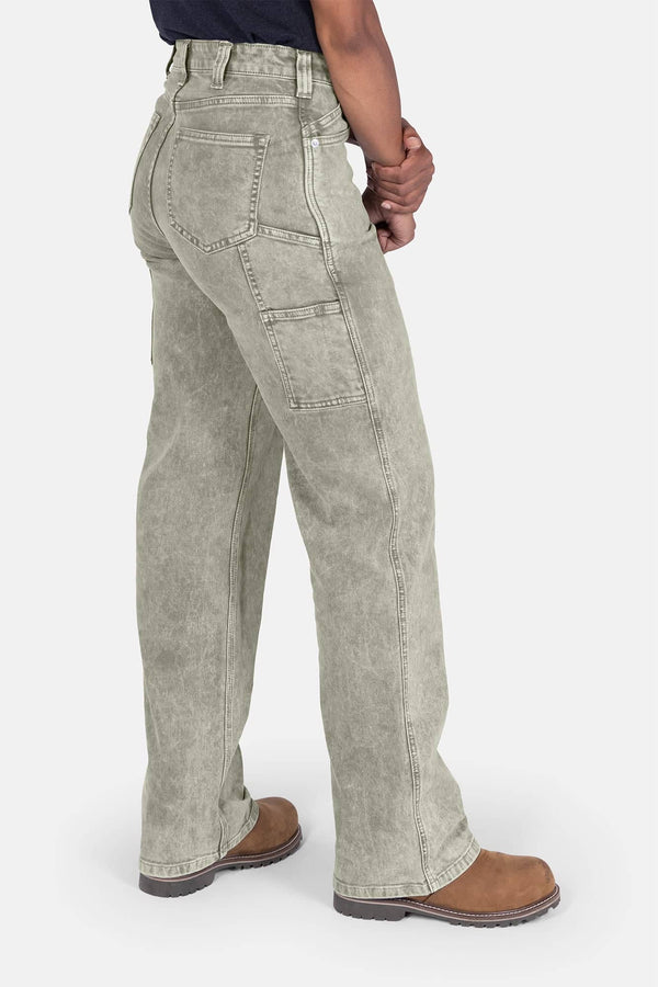 Back view of a woman wearing Dovetail Workwear's Old School Wide Leg Mineral Wash Jeans in Sunbaked Copper, showcasing the high-rise fit, nested side pockets, and wide leg silhouette