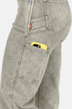 Side view of a woman wearing Dovetail Workwear's Old School Wide Leg Mineral Wash Jeans in Sunbaked Copper, with a yellow phone visible in the front cargo pocket