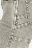 Detail shot of Dovetail Workwear Old School Wide Leg Mineral Wash Jeans showing nested side pocket, tool loop, and red brand label on denim