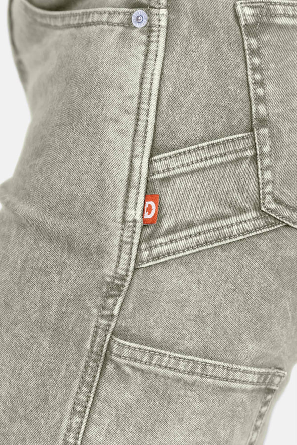 Detail shot of Dovetail Workwear Old School Wide Leg Mineral Wash Jeans showing nested side pocket, tool loop, and red brand label on denim