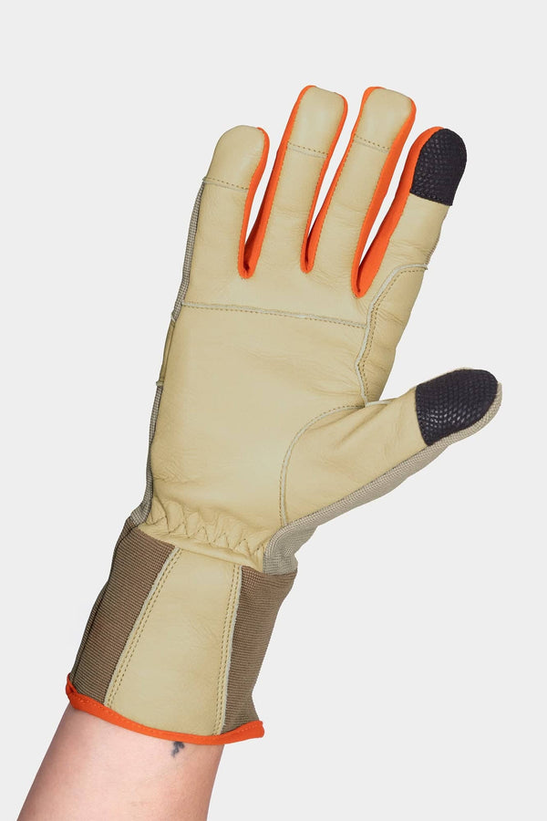 Performance Work Gloves in Light Kodiak by Dovetail Workwear, shown on a woman's hand displaying the touchscreen-sensitive fingertips and adjustable wrist strap