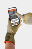 Woman's hand holding a smartphone displaying the Dovetail Workwear website while wearing Light Kodiak Performance Work Gloves with touchscreen-sensitive index finger and thumb and extended cuff
