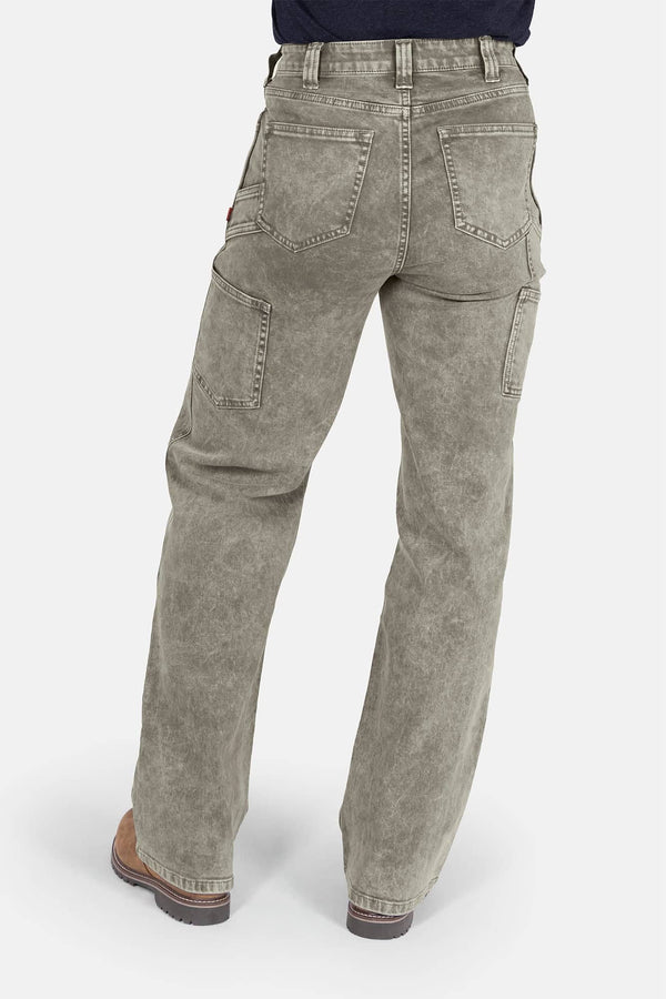 Back view of Dovetail Workwear's Old School Wide Leg Mineral Wash Jeans in Sunbaked Eucalyptus, showing nested side pockets and high-rise fit on a woman