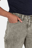 Detail view of a woman's hand in the pocket of Dovetail Workwear's Old School Wide Leg Mineral Wash Jeans in Sunbaked Eucalyptus, showing the nested side pocket design