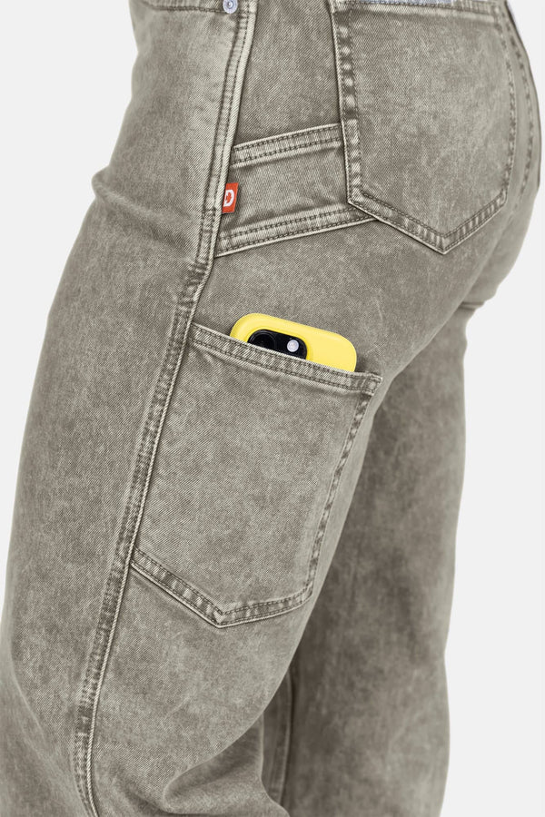 Detail shot of the Old School Wide Leg Mineral Wash Jeans in Sunbaked Eucalyptus by Dovetail Workwear, showing a yellow tool in the nested side pocket