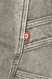Close-up detail of the Dovetail Workwear Old School Wide Leg Mineral Wash Jeans in Sunbaked Eucalyptus, showing the nested side pocket and brand label on gray denim fabric