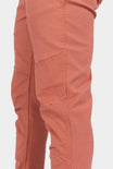 Side view of a woman wearing Dovetail Workwear GO TO™ Pants in Terracotta, highlighting the articulated knee and reinforced knee design in stretch canvas.