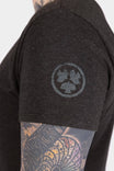 Side view of a woman wearing the Dovetail Workwear GO TO™ Crew Neck Tee in Black, featuring a cotton jersey blend fabric