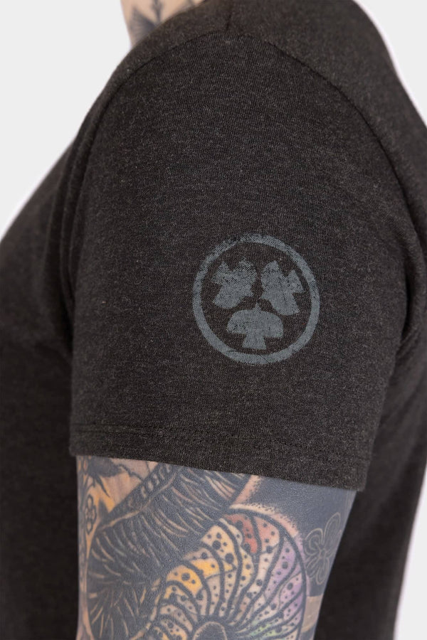 Side view of a woman wearing the Dovetail Workwear GO TO™ Crew Neck Tee in Black, featuring a cotton jersey blend fabric