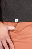 Close-up detail of the Dovetail Workwear GO TO™ "Woman Up" Graphic Work Tee in charcoal, showing the soft cotton jersey blend fabric and relaxed fit on a woman