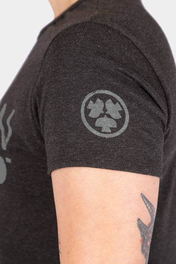 Side view of a woman wearing the Dovetail Workwear GO TO "Woman Up" Graphic Work Tee, featuring the circular front graphic design