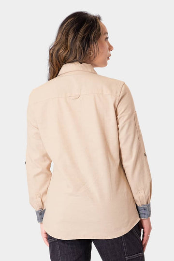 Back view of a woman wearing the Dovetail Workwear Givens Long Sleeve Summer Work Shirt in Ecru White, showing the button chest pocket and contrast inner cuffs