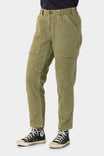 Range Crop Pant in Kelp Green by Dovetail Workwear displayed on a woman wearing black sneakers, showcasing the relaxed leg fit and bellowed front pocket details