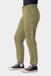 Side view of a woman wearing Dovetail Workwear Range Crop Pant in Kelp Green, featuring bellowed front pockets and a relaxed leg silhouette, paired with black high-top sneakers