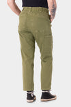 Back view of a woman wearing Dovetail Workwear's Range Crop Pant in Kelp Green, showcasing the bellowed front pockets and relaxed leg cropped silhouette