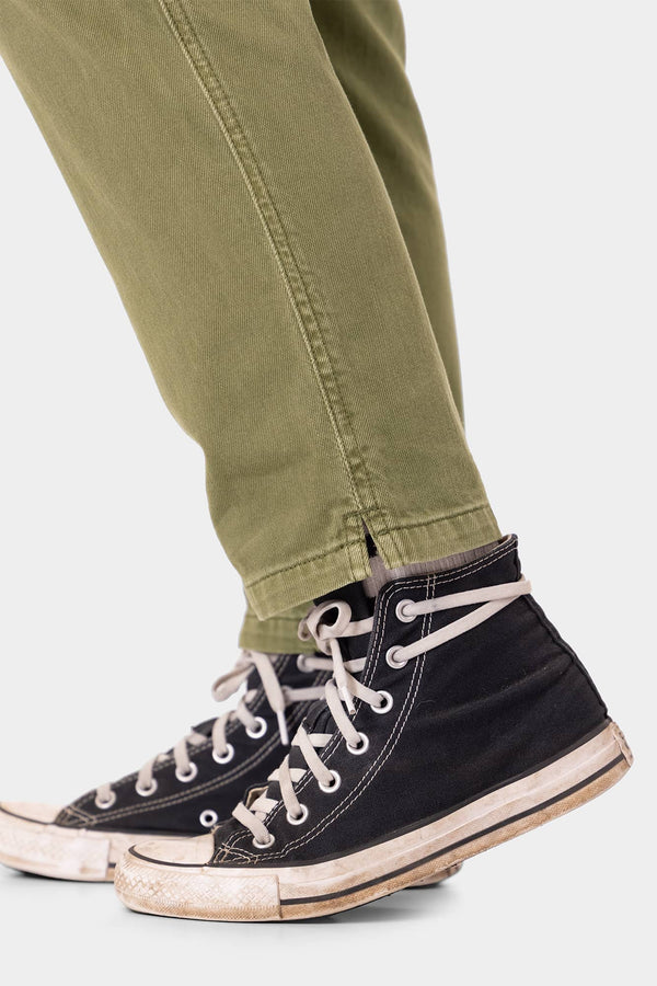 Detail view of Dovetail Workwear Range Crop Pant in Kelp Green, cropped at ankle and paired with black high-top sneakers