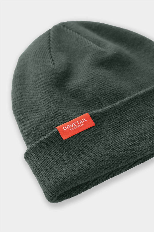 Lodge Green Dovetail Beanie from Dovetail Workwear displayed with cuffed fit, featuring the brand's woven logo on soft acrylic knit fabric