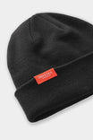 Black Dovetail Beanie by Dovetail Workwear featuring a cuffed knit design with a Dovetail logo, displayed against a white background